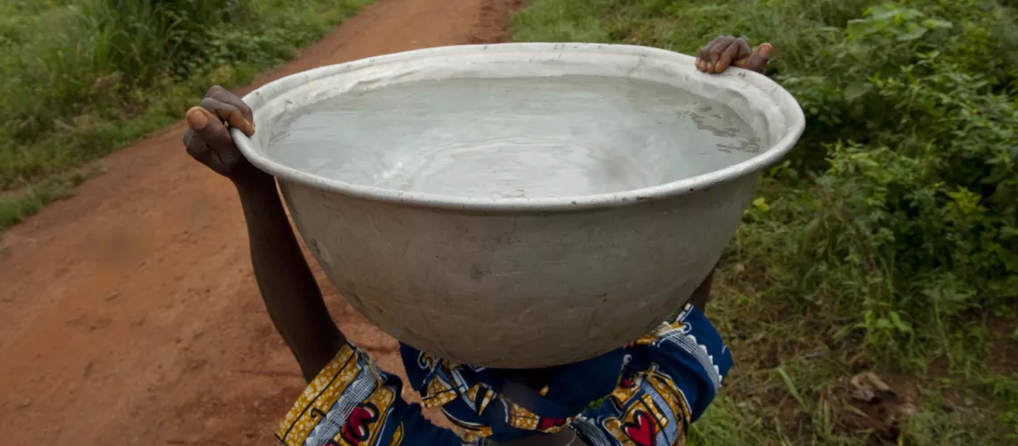 People carrying clean water in Woukpokpoe village. Photo credit: Arne Hoel/World Bank